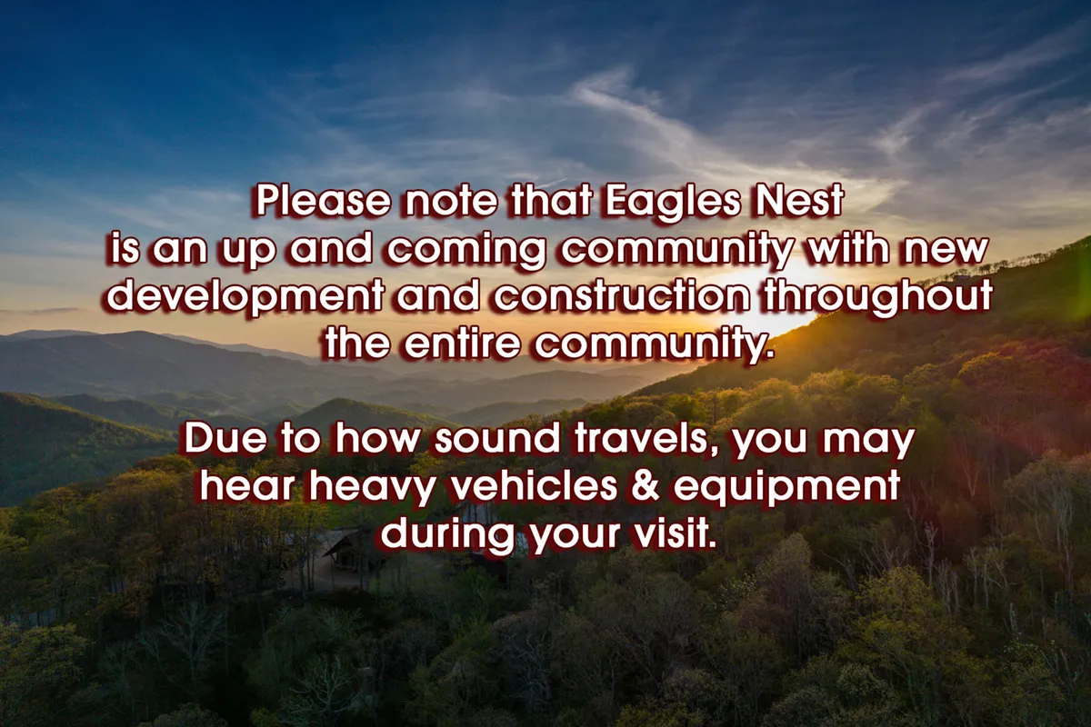 A sweeping mountain landscape with a vibrant sunset sky and lush greenery, capturing the natural beauty and recreational opportunities in Eagles Nest. The view suggests nearby walking trails and a welcoming community setting.
